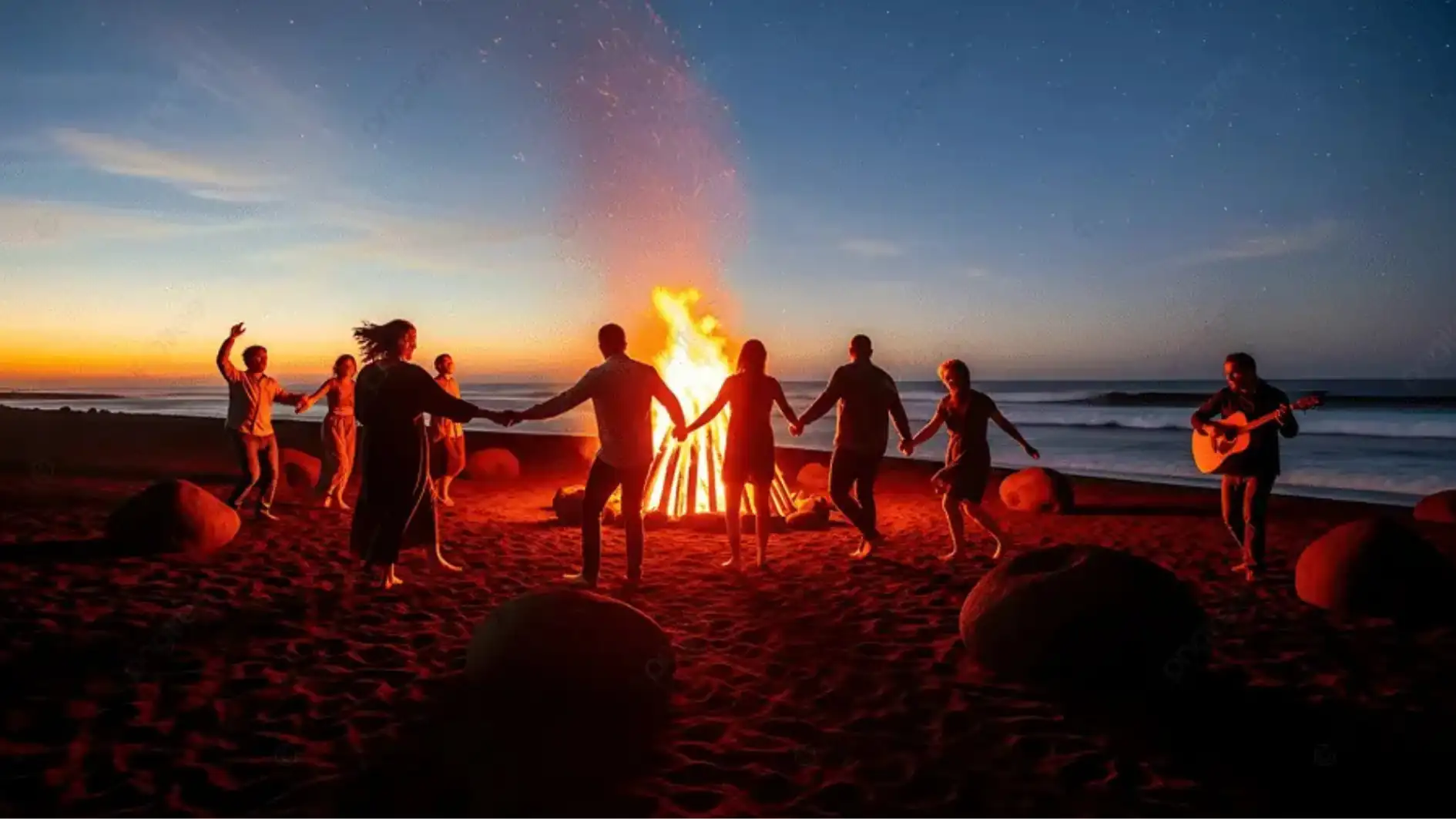 Tim kantor duduk melingkar di sekitar bonfire pantai